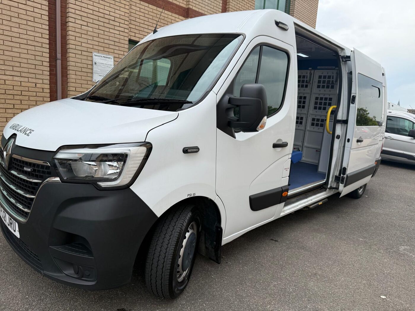 PSS secure ambulance with the side door open showing the secure compartment